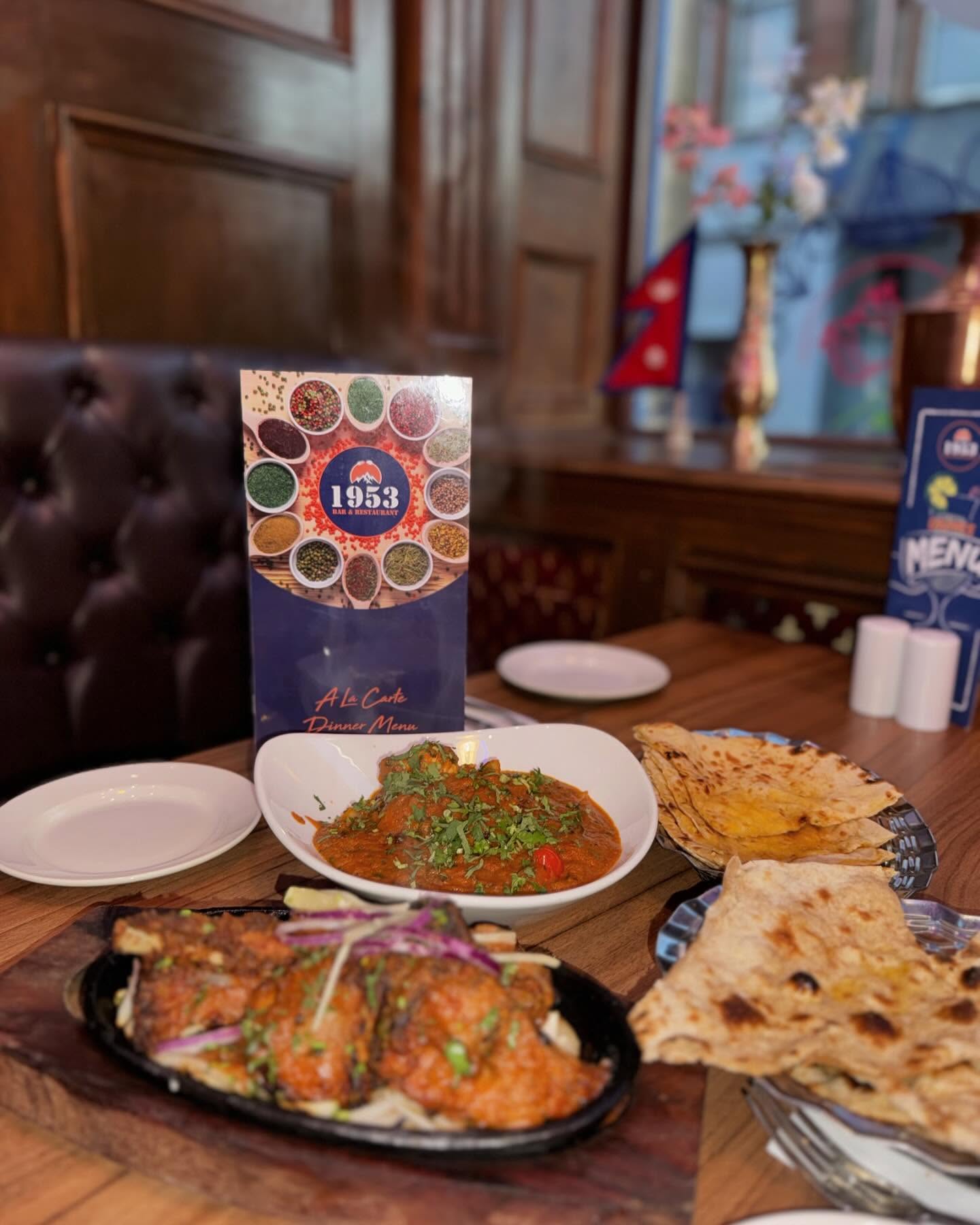 A feast of curry, naan and sizzling dishes